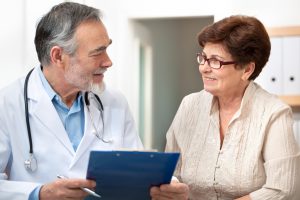 doctor talking to his female patient at office