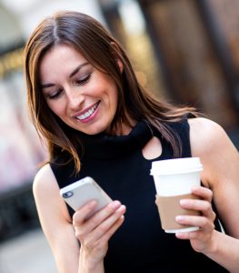 Busy business woman texting; on-the-go lifestyle and unified communications